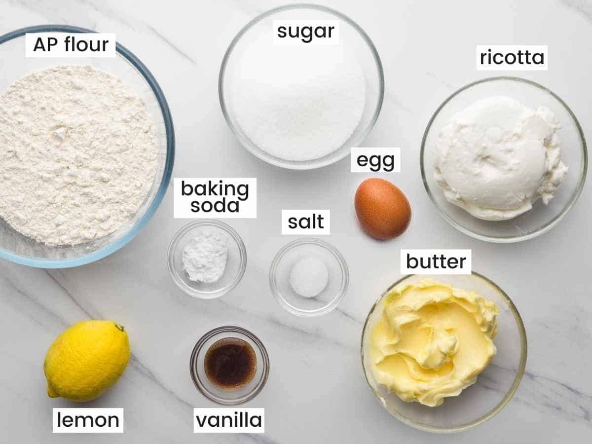 Ingredients needed to make ricotta cookies including flour, sugar, egg, butter, ricotta, baking soda, salt, and vanilla.