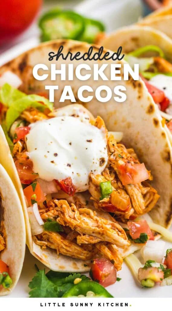 Shredded chicken taco, close up shot. With overlay text that says "shredded chicken tacos"