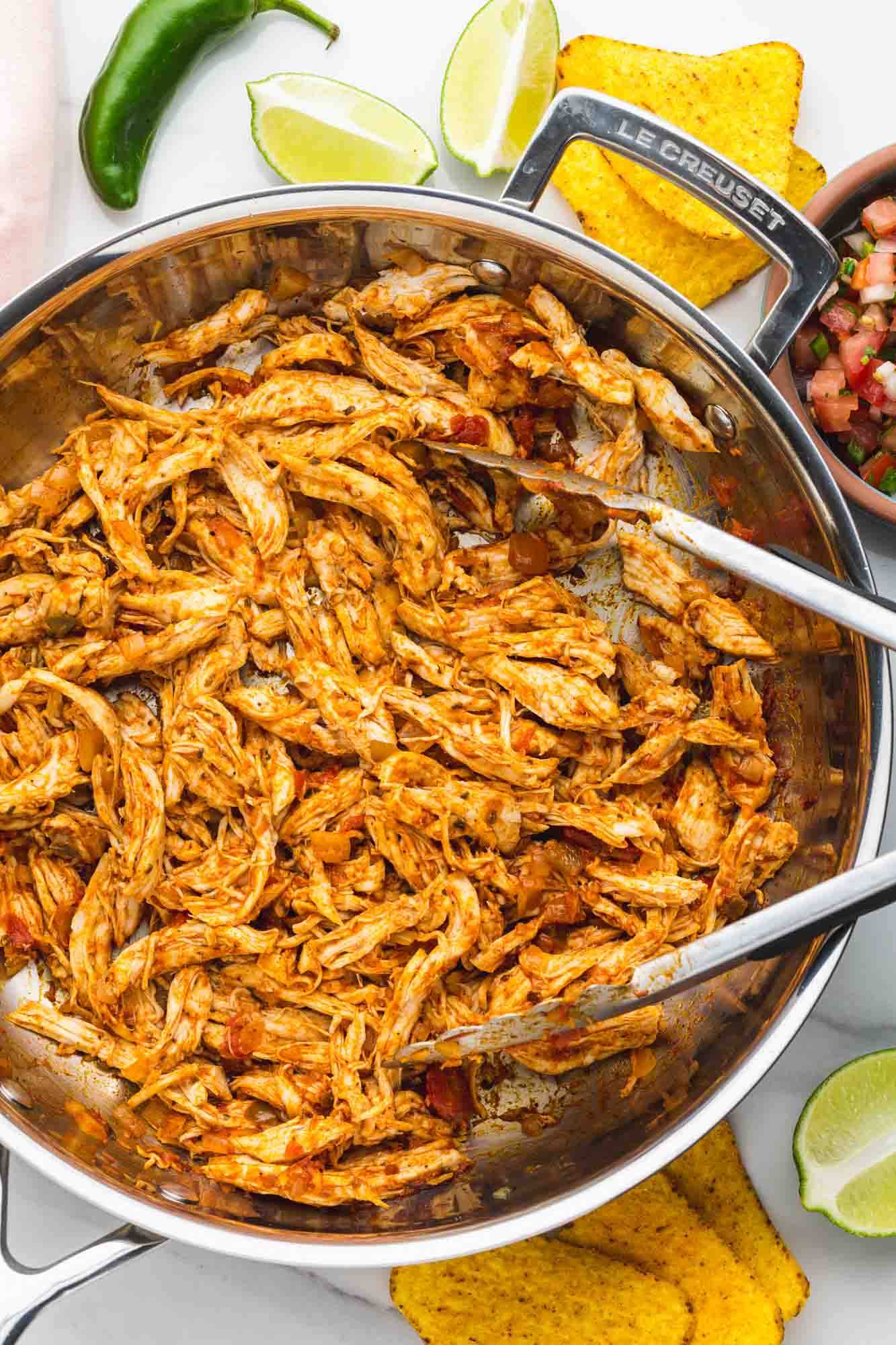 Shredded chicken taco meat in a skillet