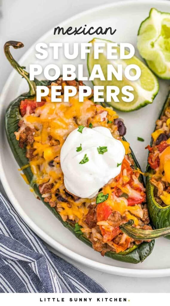 Stuffed poblano pepper on a plate with sour cream, and lime wedges. With overlay text that says "Mexican stuffed poblano peppers"