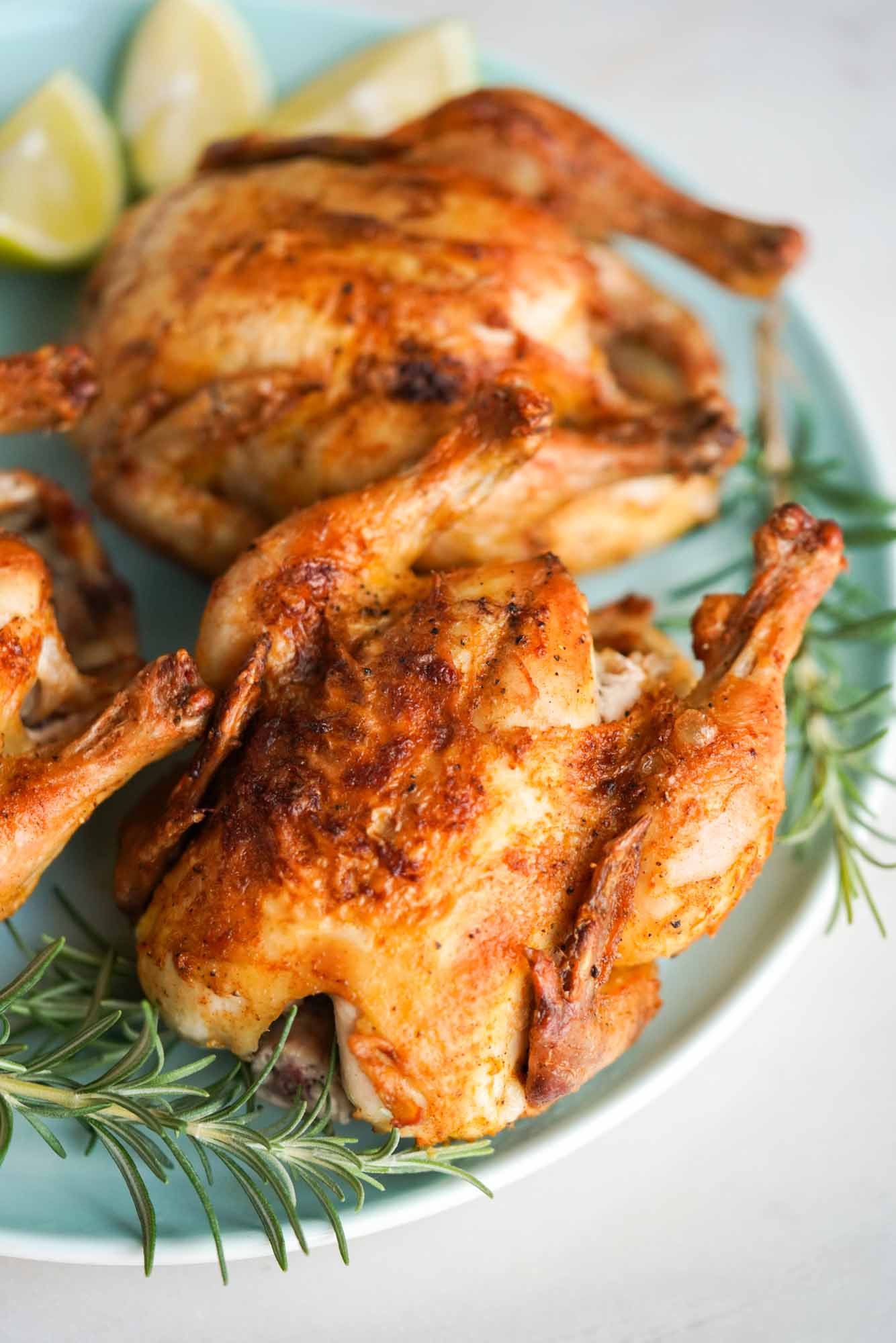 Air Fried cornish hen served on a plate with fresh rosemary