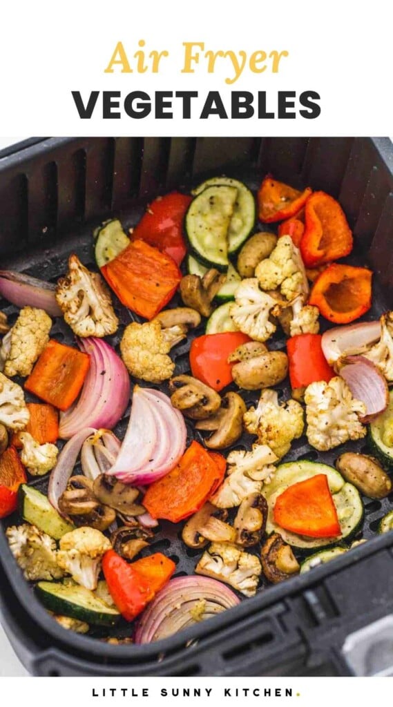 Roasted mixed vegetables in an air fryer basket, and overlay text that says "Air fryer vegetables"
