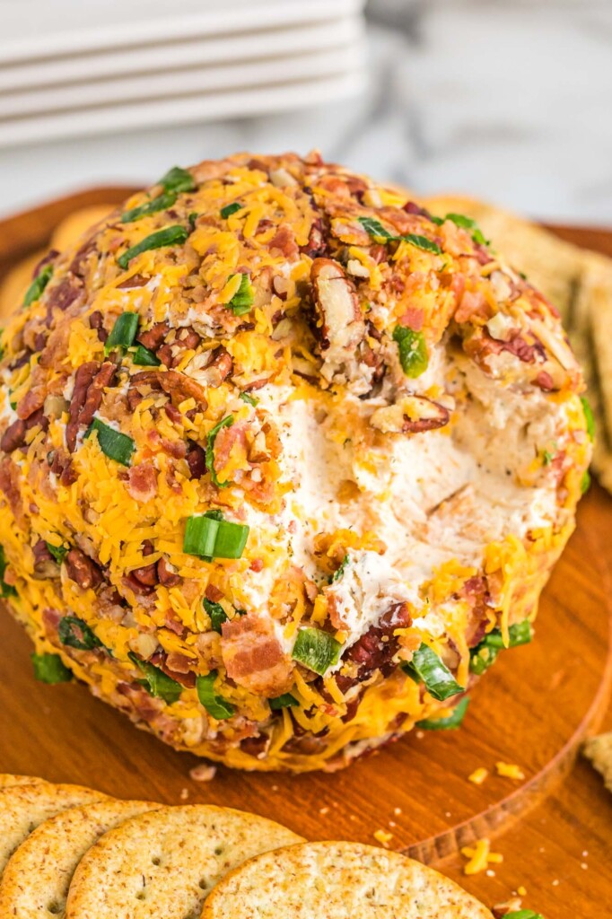 How to Make Bacon Ranch Cheese Ball served on a wooden board with crackers