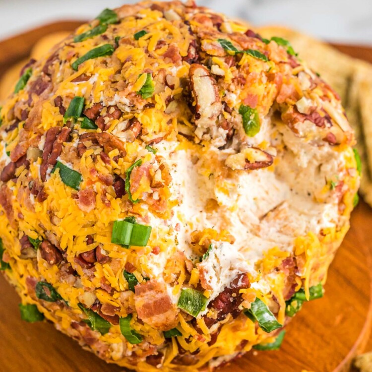 How to Make Bacon Ranch Cheese Ball served on a wooden board with crackers