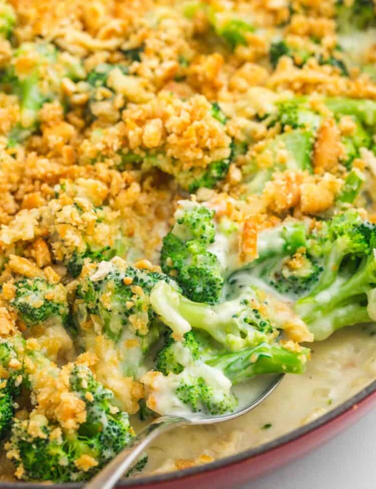 Serving creamy broccoli casserole with a serving spoon