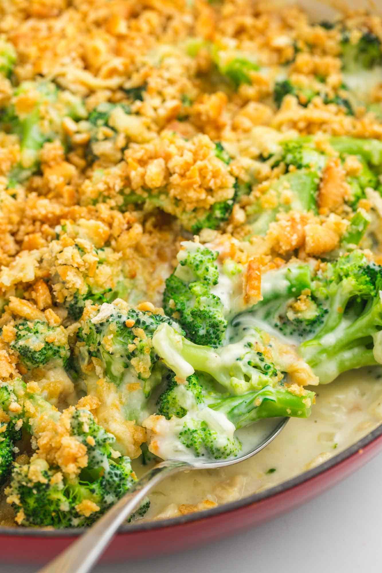 Serving creamy broccoli casserole with a serving spoon