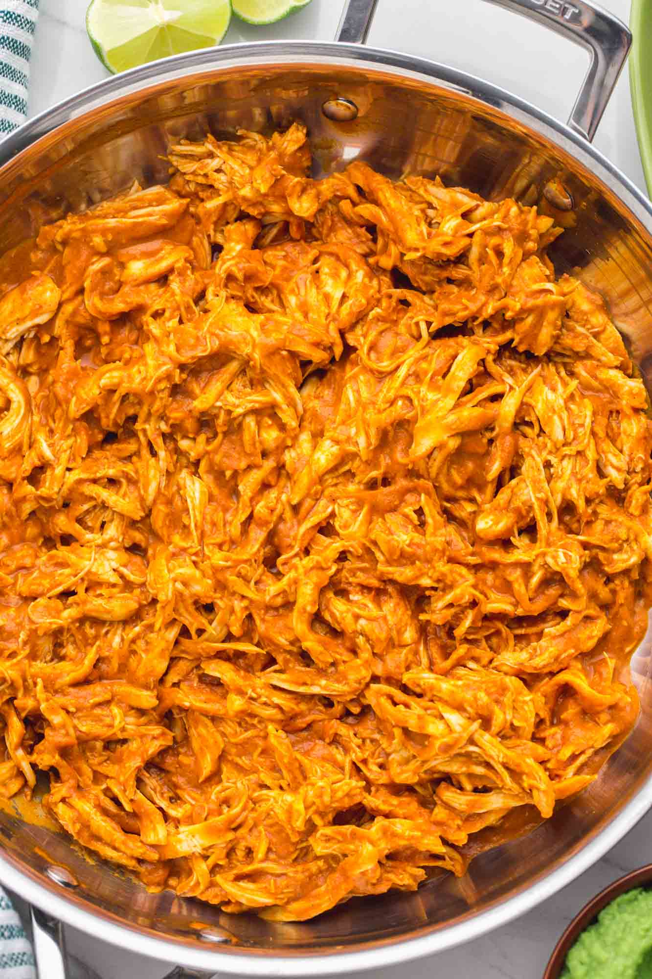 Chicken tinga in a stainless skillet made with shredded chicken