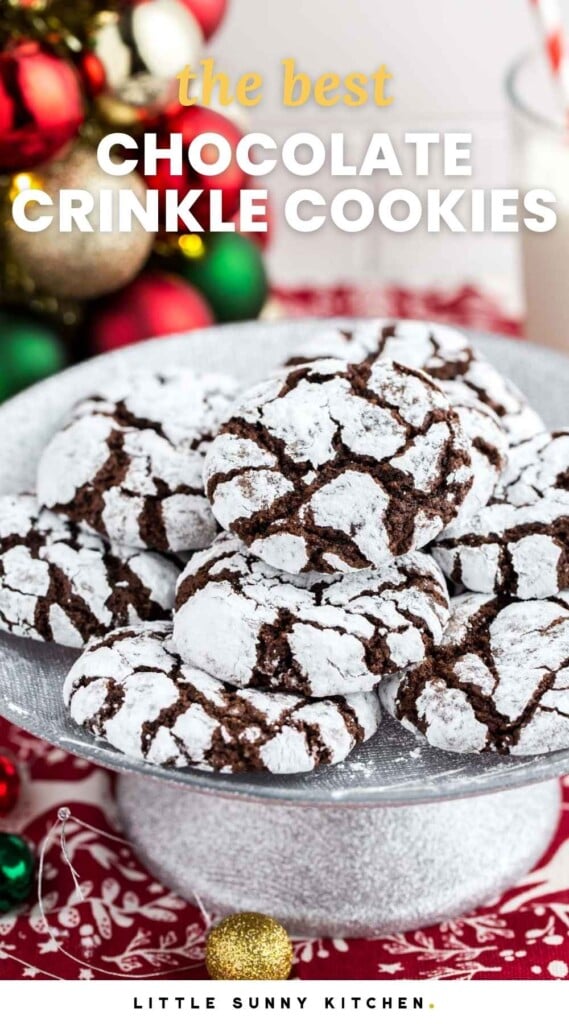Chocolate crinkle cookies served on a small silver cake stand, and overlay text that says "the best chocolate crinkle cookies"