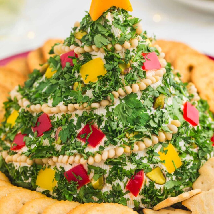 Christmas tree shaped cheese ball with Ritz crackers around it