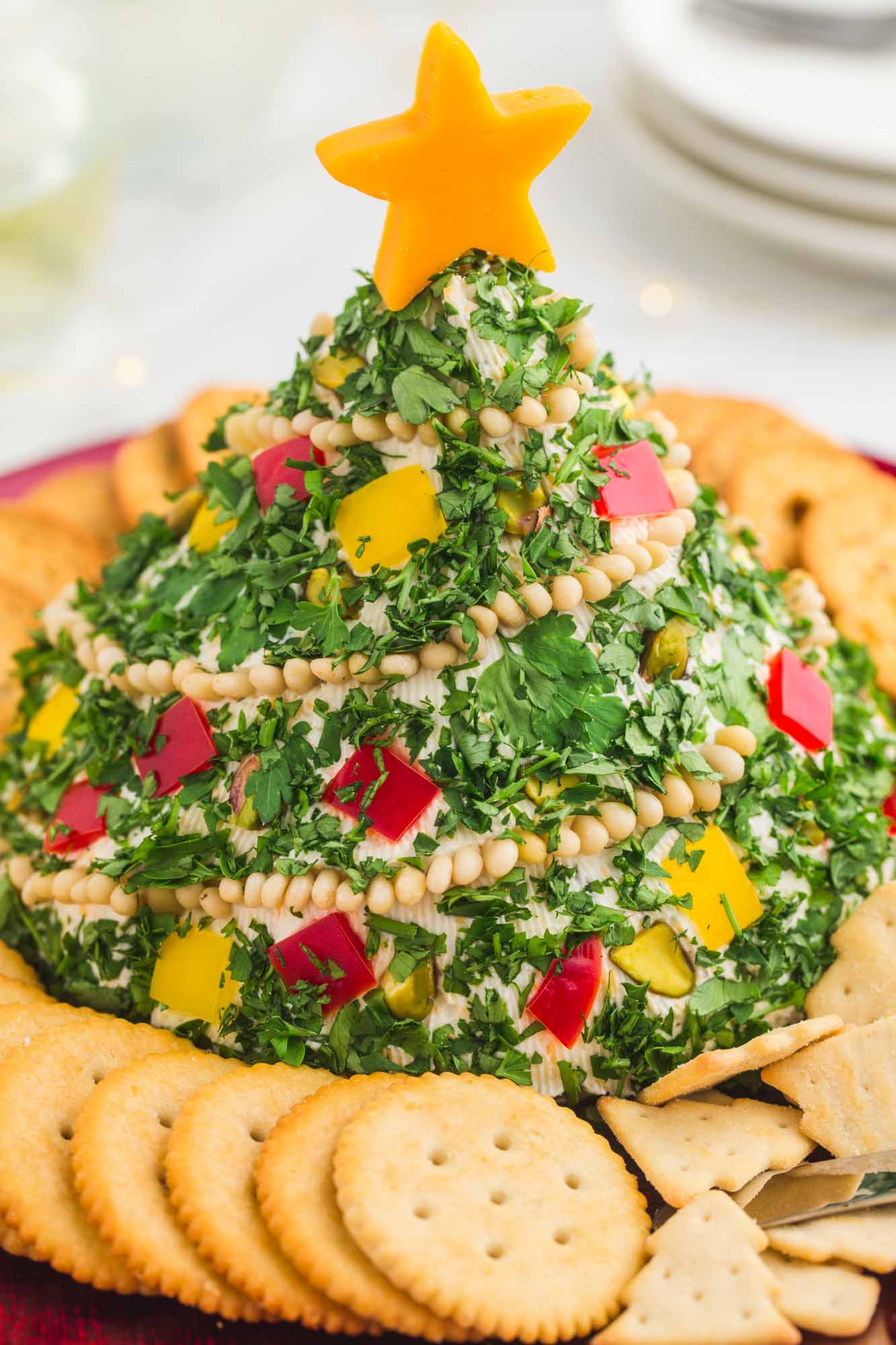 Christmas tree shaped cheese ball with Ritz crackers around it