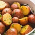 Cooked baby red potatoes in a green bowl