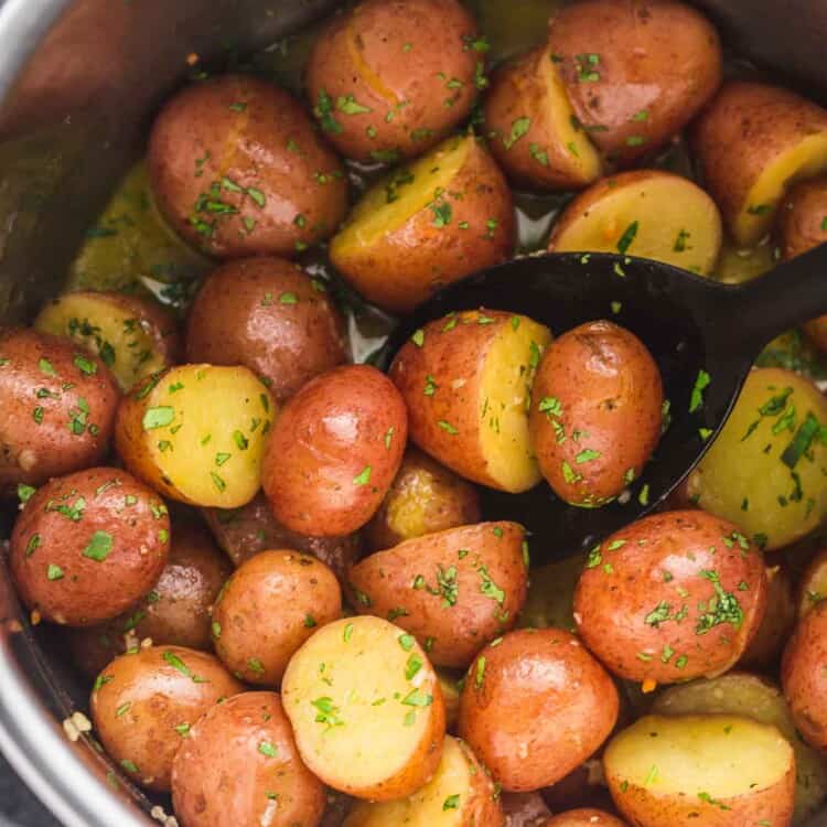 Close-up of baby red potatoes in the Instant Pot, cooked with garlic butter and herbs
