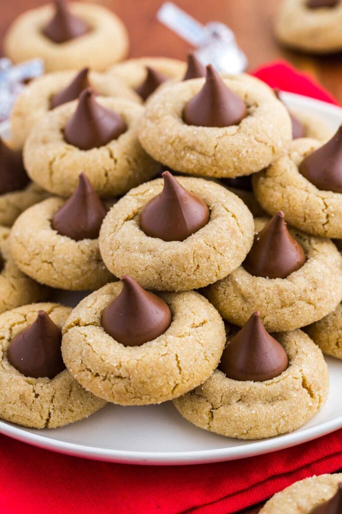 Stacked peanut butter blossoms served on a white plate