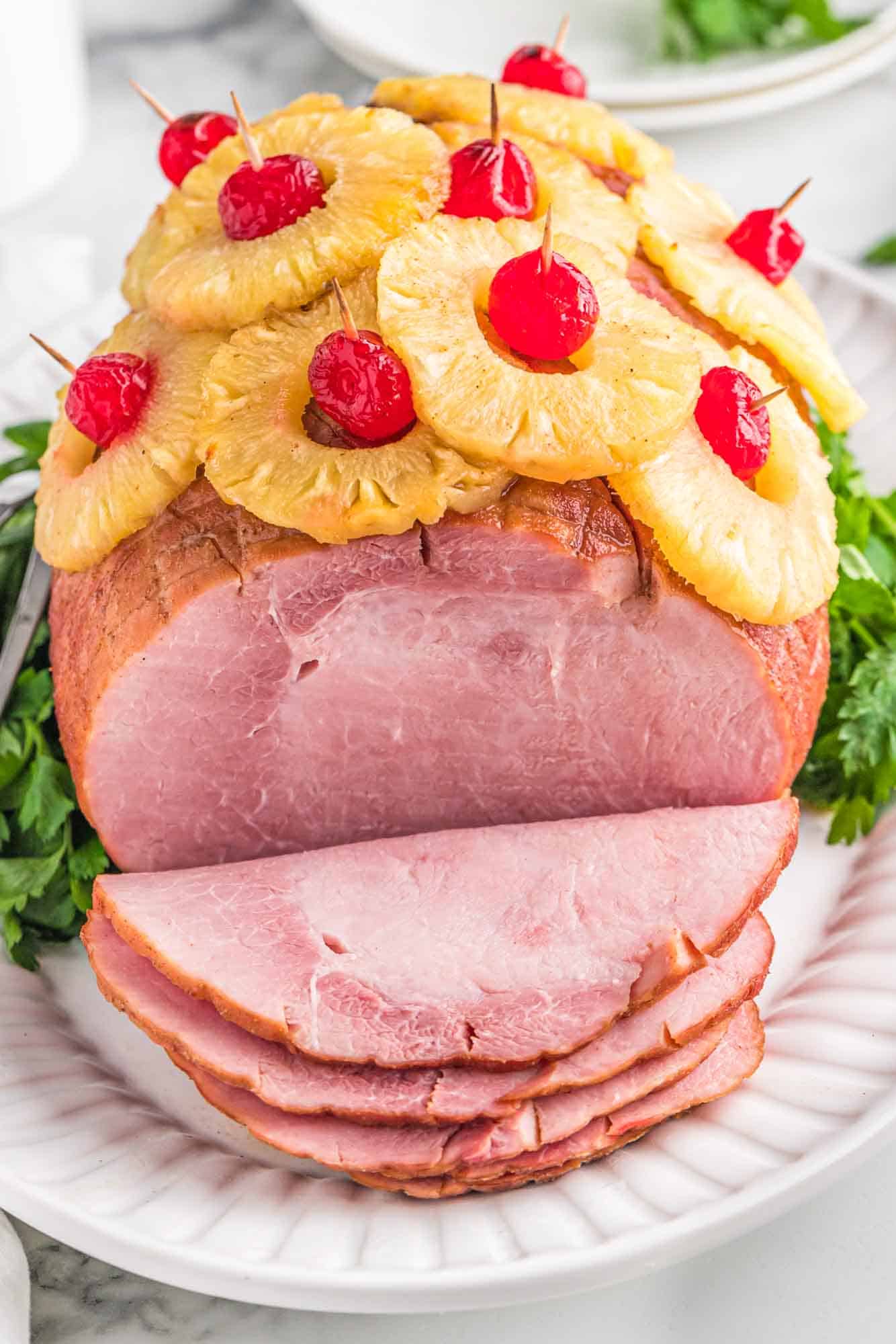 Sliced pineapple ham served on a white plate