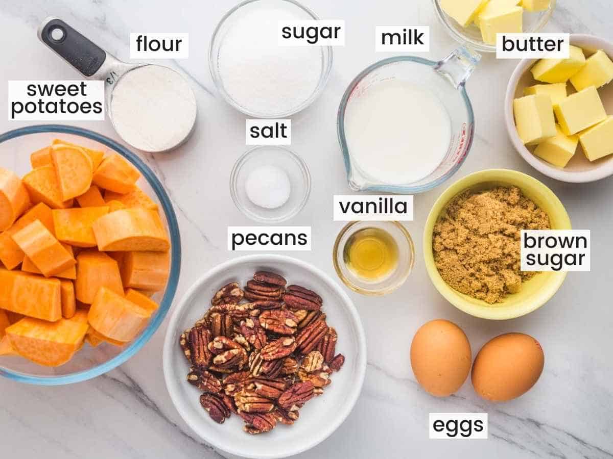 Ingredients needed for sweet potato casserole including sweet potatoes, milk, butter, flour, pecans, eggs, vanilla, butter.