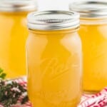 Three cans of clear sunny homemade turkey stock.