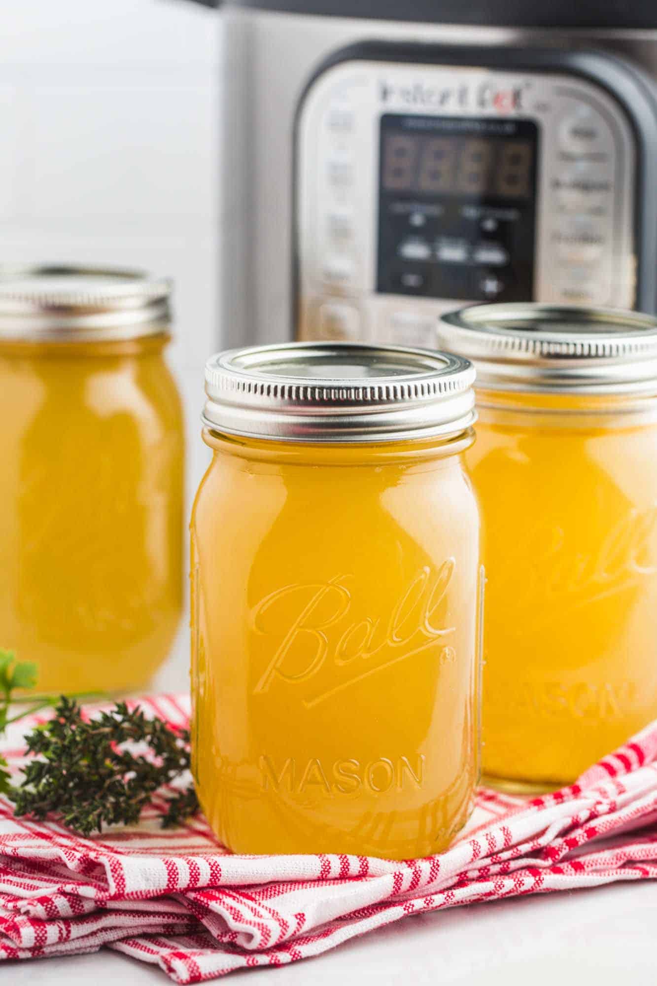 Turkey stock in jars, and an instant pot in the background.
