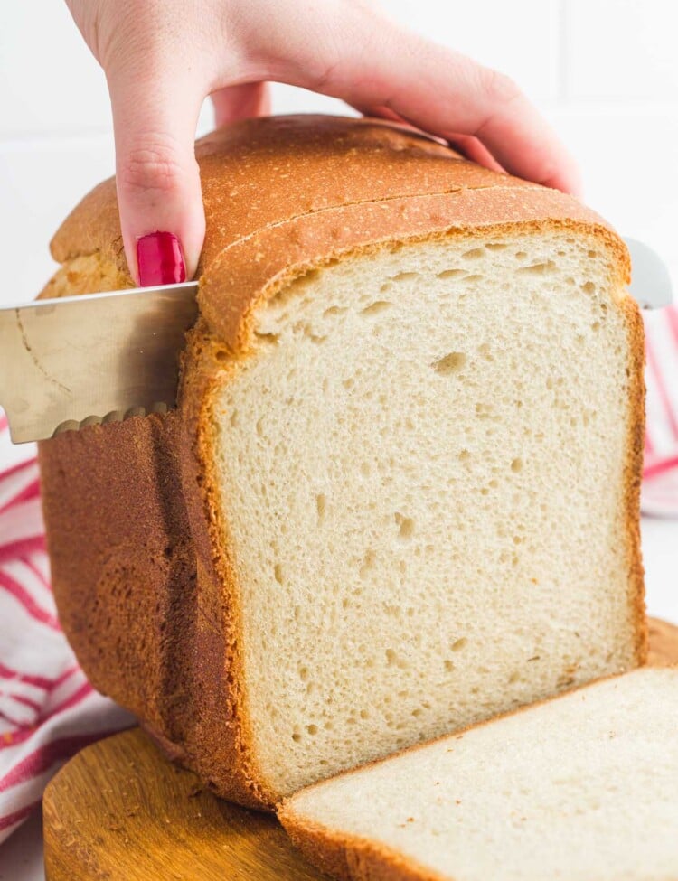 Cutting into a white loaf baked in a bread machine