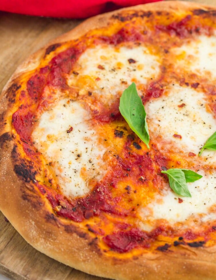 Perfect simple baked pizza, with mozzarella and fresh basil leaves.
