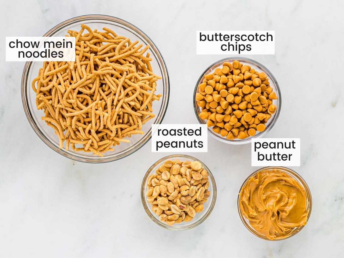 Ingredients to make haystack cookies including chow mein noodles, butterscotch chips, peanuts, and peanut butter.