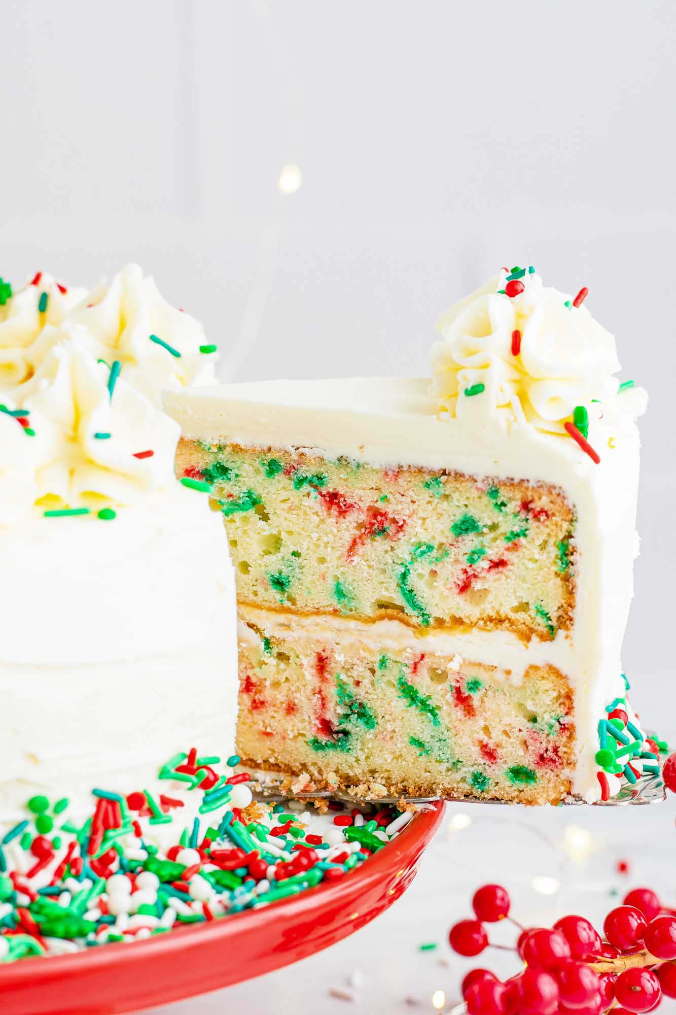 Taking a slice of Christmas funfetti cake from the whole cake