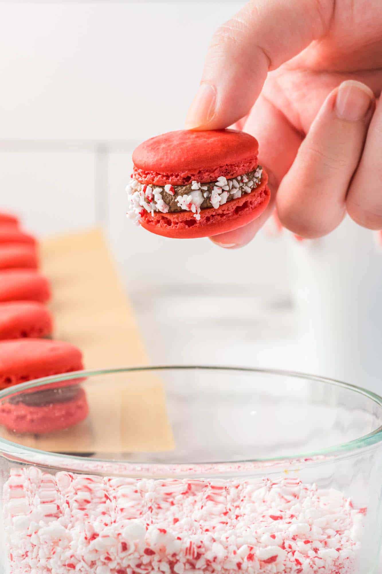 Dipping the macarons in crushed candy canes