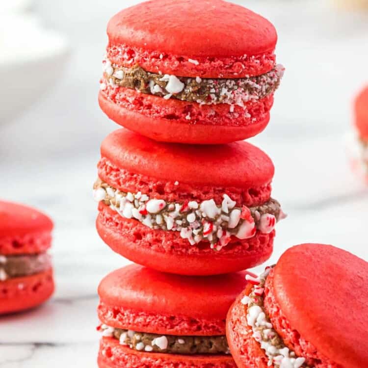 Three peppermint red macarons with chocolate filling stacked
