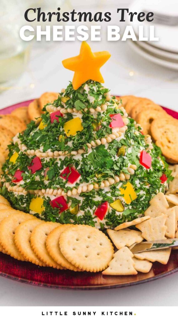 Christmas tree shaped cheese ball served with crackers. With overlay text that says "Christmas tree cheese ball"