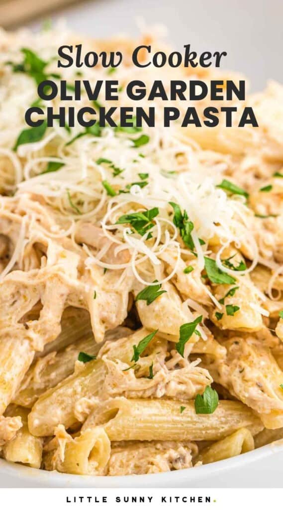 Close up shot of creamy chicken pasta with parmesan and parsley, with overlay text that says "Slow cooker olive garden chicken pasta"
