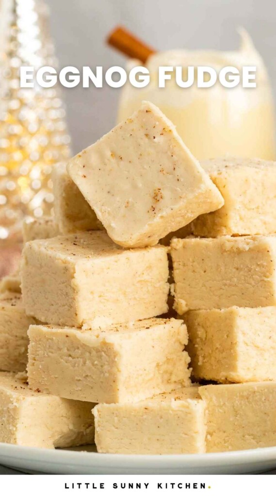 Stacked eggnog fudge squares, with overlay text that says "eggnog fudge"