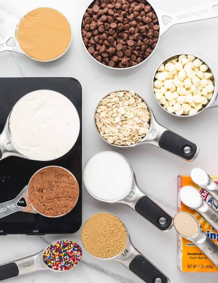 Overhead shot showing measured out baking ingredients such as flour, sugars, chocolate chips, oats.