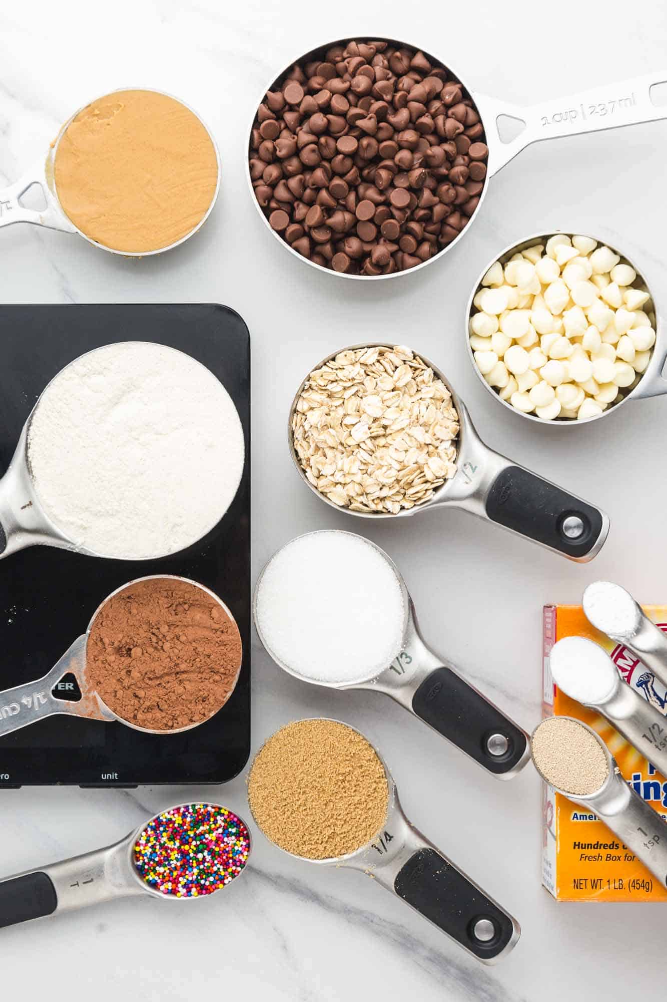 Overhead shot showing measured out baking ingredients such as flour, sugars, chocolate chips, oats.
