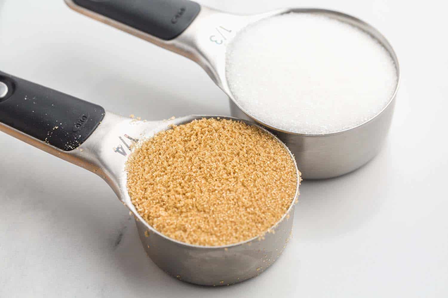 granaulated sugar and light brown sugar in measuring cups