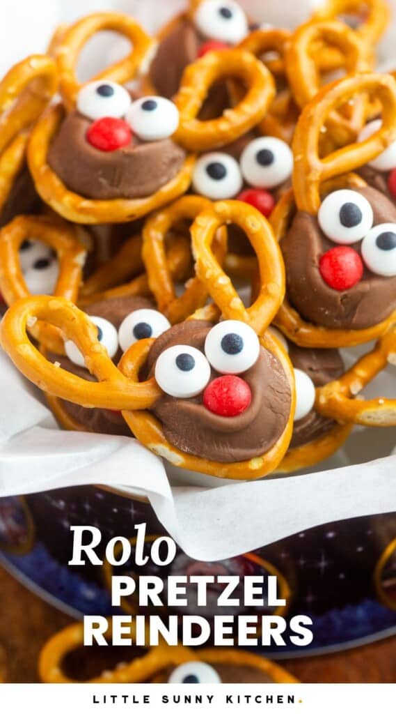 Rolo Reindeer Pretzels in a bowl lined with parchment paper, and overlay text that says "Rolo Pretzel Reindeers"
