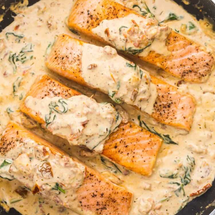 Overhead shot of tuscan salmon in a pan with cream sauce