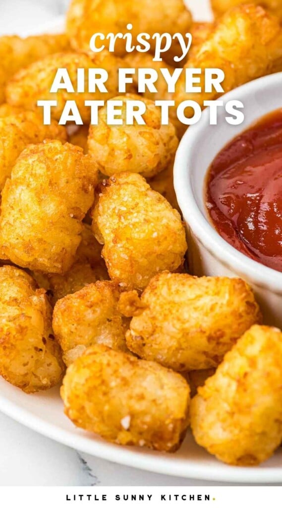 Crispy golden tater tots on a white plate served with ketchup, and overlay text that says "Crispy air fryer tater tots"