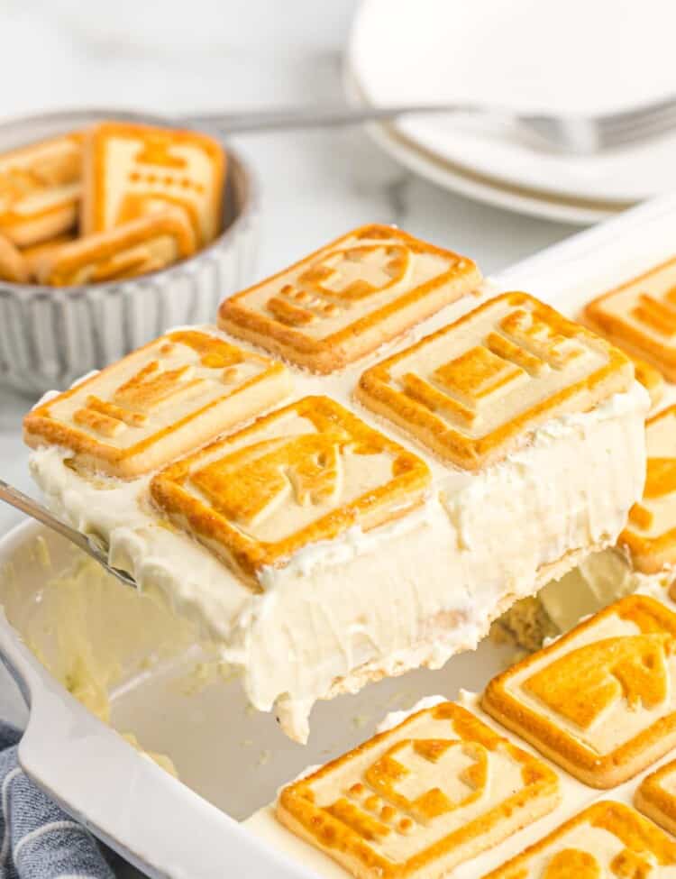 Taking a serving of Chessmen banana pudding from the ceramic dish