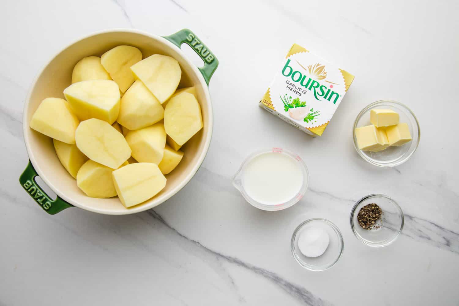 Ingredients needed to make boursin mashed potatoes including potatoes, boursin cheese, milk, butter, salt and pepper.
