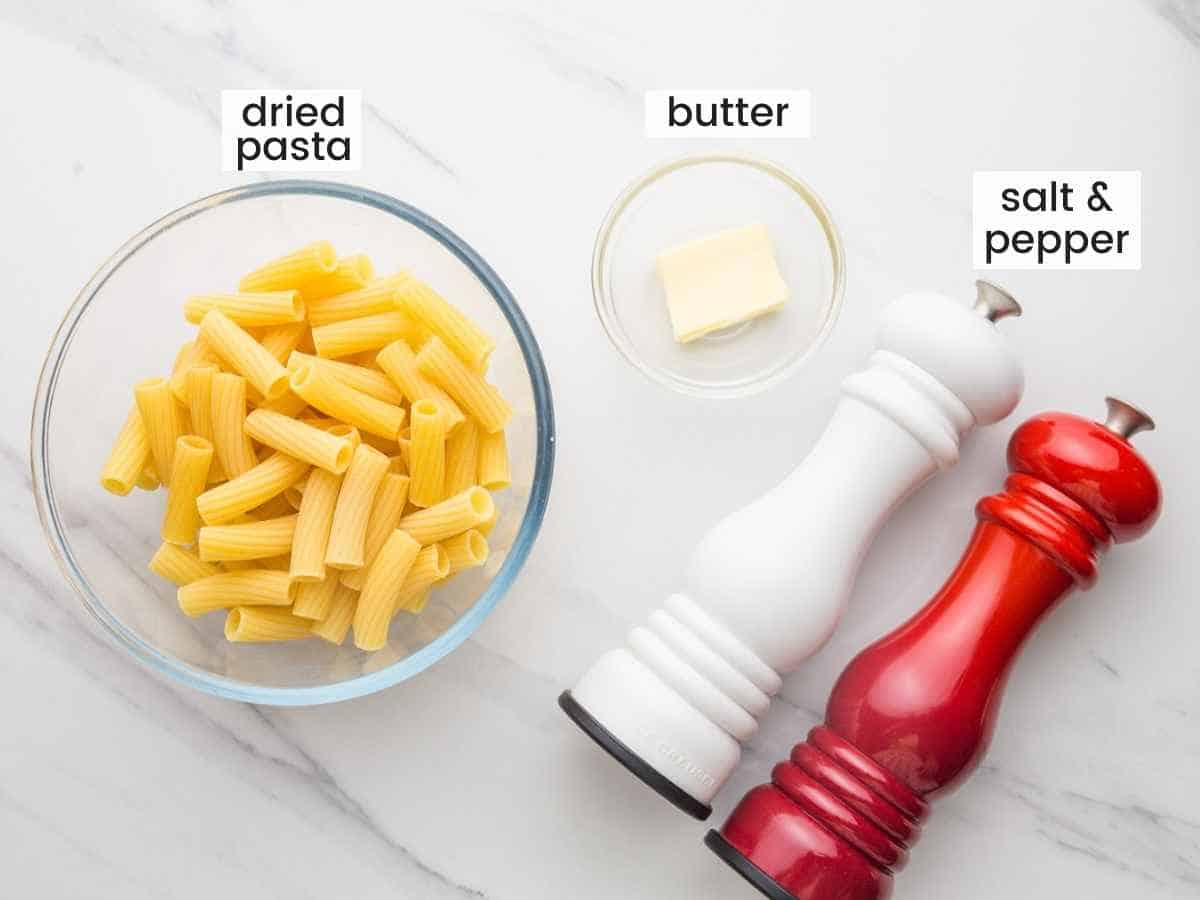 Ingredients needed to make buttered noodles including pasta, butter, salt and pepper.