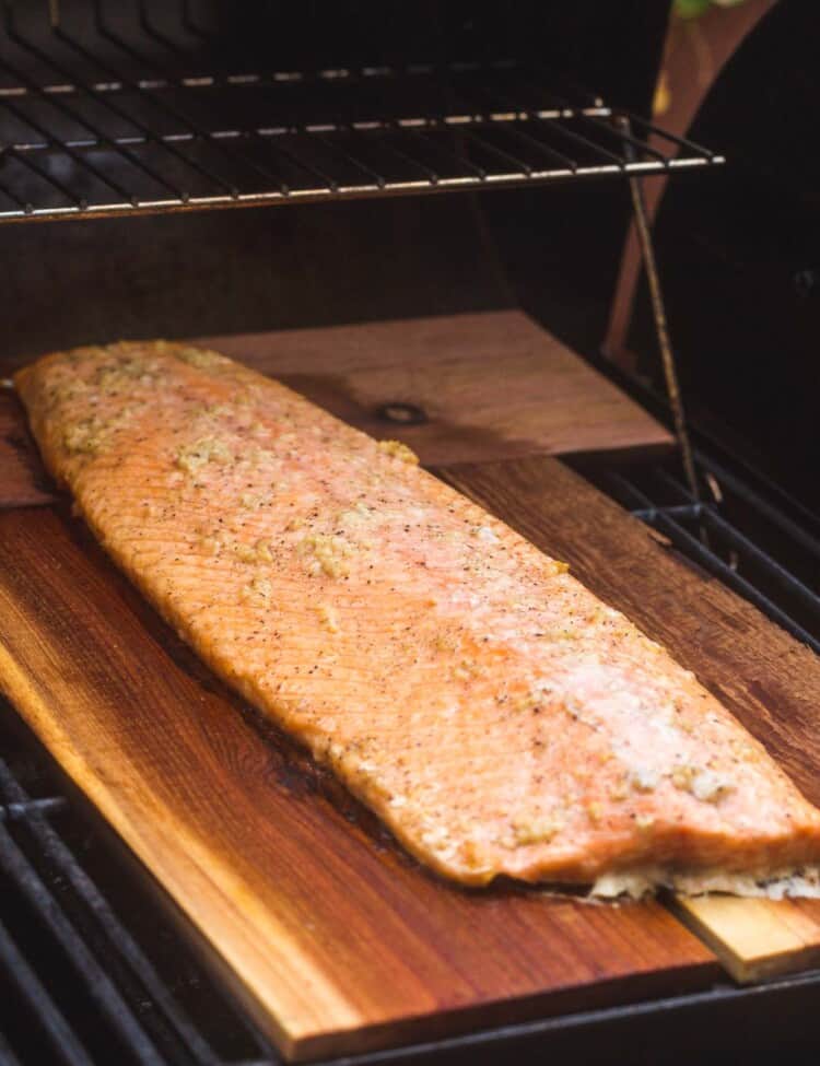 Half size of salmon cooked on a cedar plank on the grill