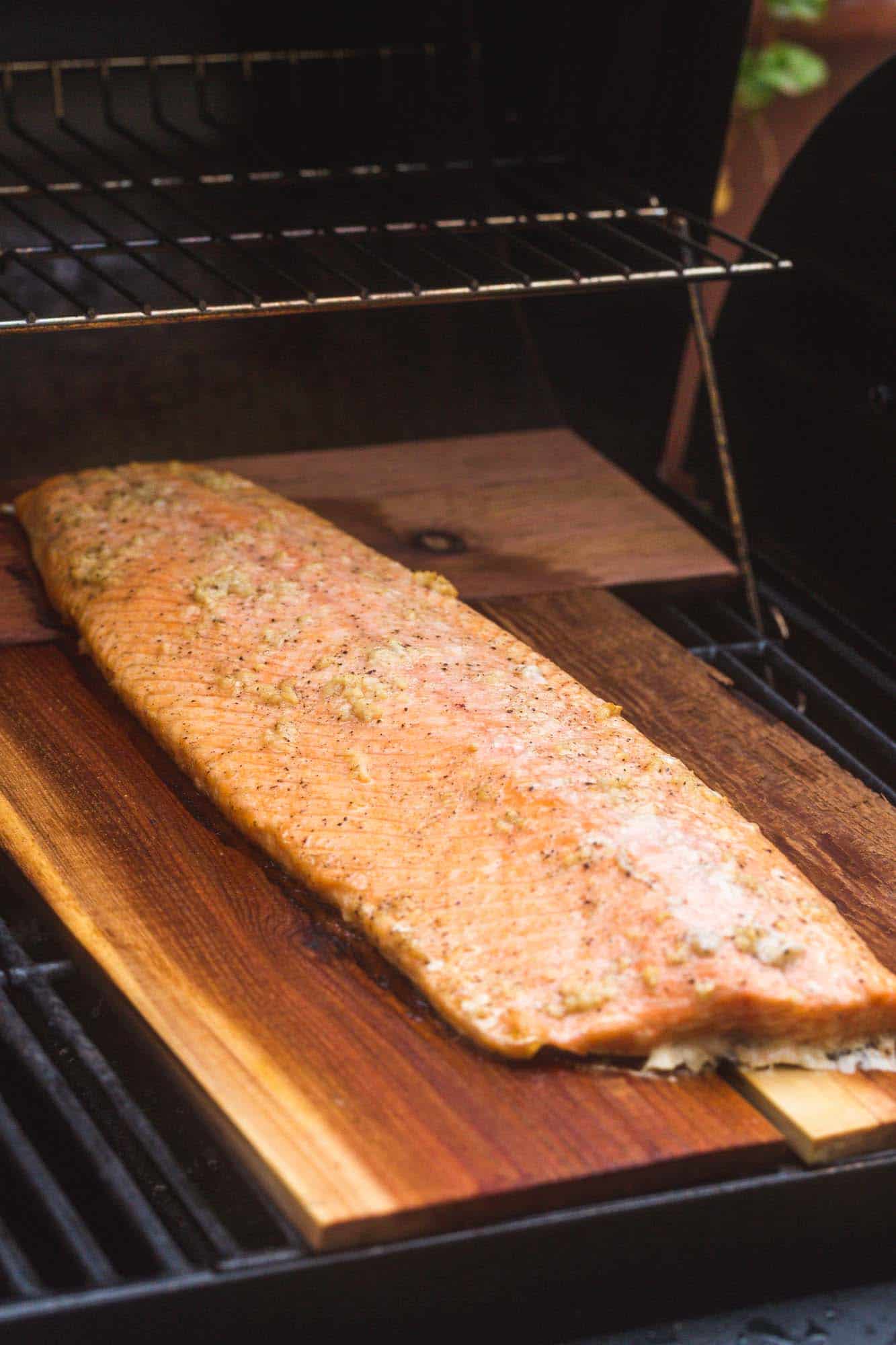 Half size of salmon cooked on a cedar plank on the grill