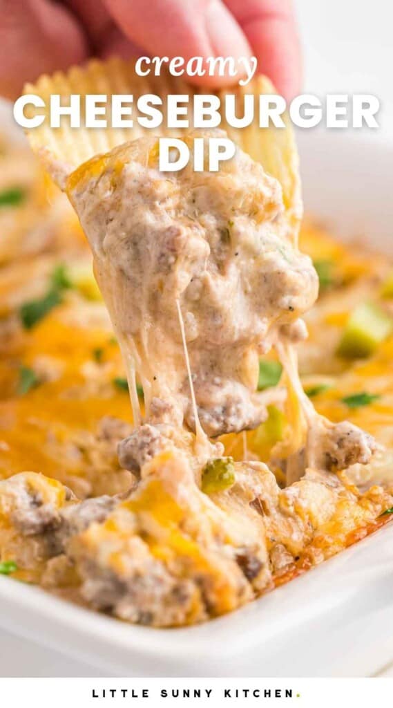 Dipping a potato chip in melty and hot cheeseburger dip, and overlay text that says "creamy cheeseburger dip"