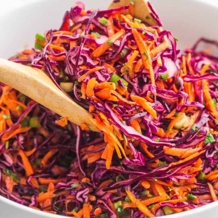 Tossing and serving red cabbage slaw using 2 wooden spoons