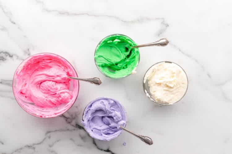 4 bowls of buttercream in different colors