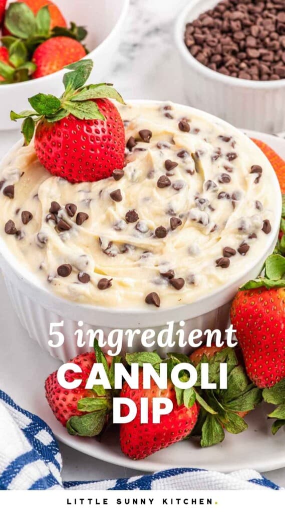 Cannoli dip served in a small white bowl, topped with a strawberry and served with fresh strawberries on the side. And overlay text that reads "5 ingredient cannoli dip"