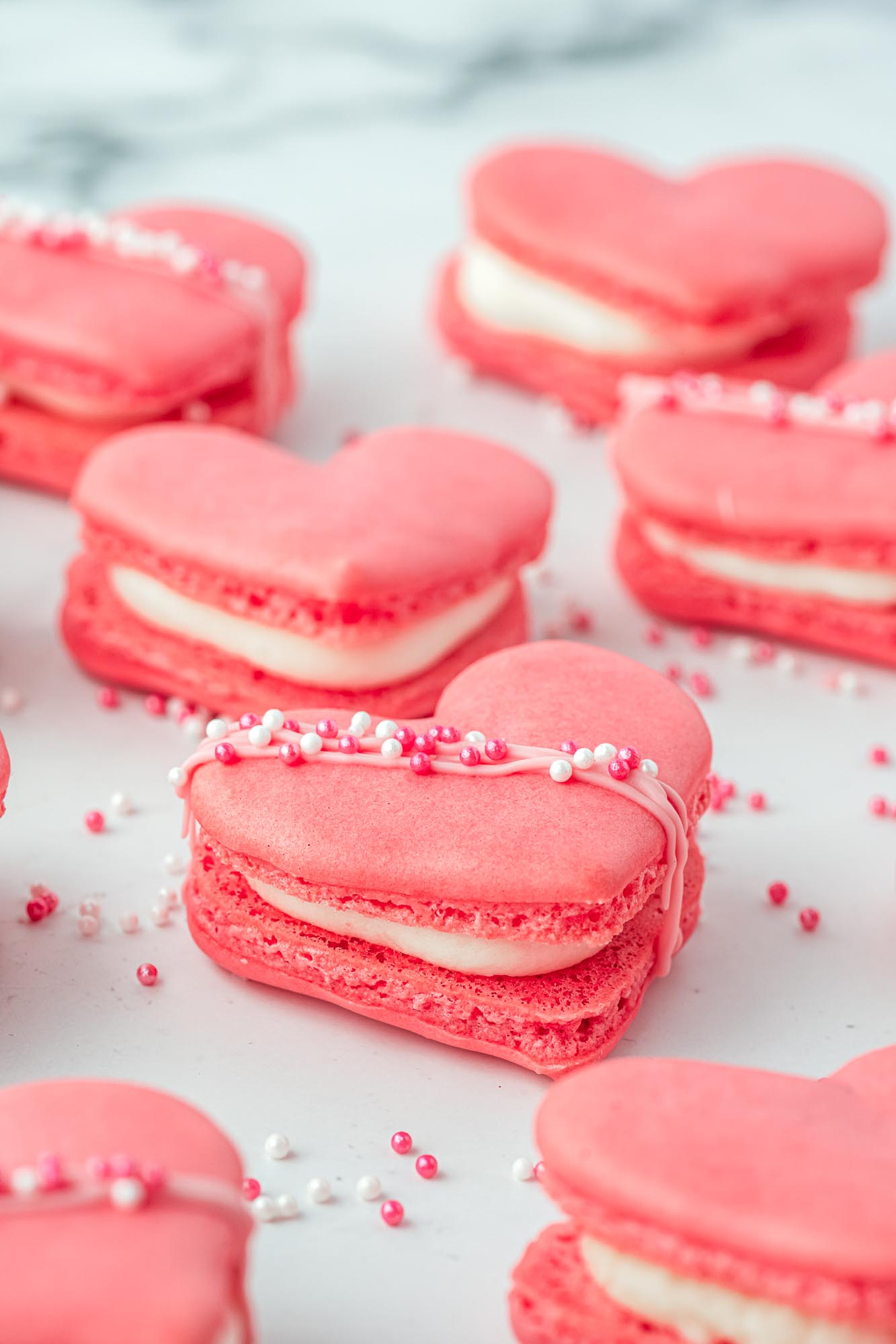 Heart macarons, a shot with an angle to show the filling.