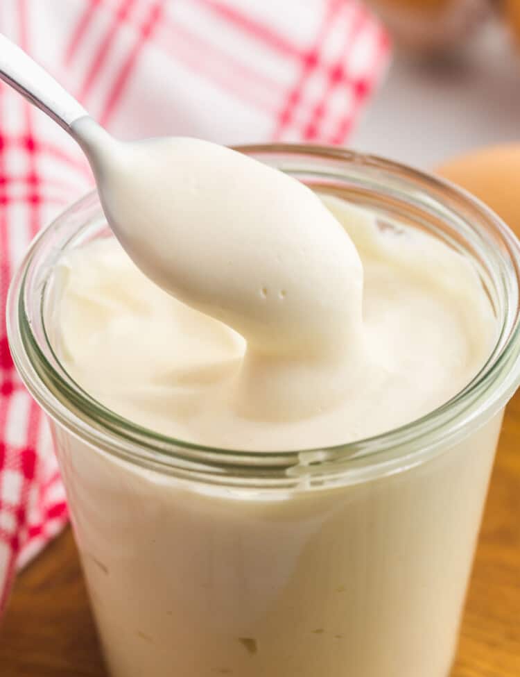 Homemade mayo in a glass Weck jar with a small spoon