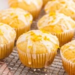 Iced orange muffins on a wire rack