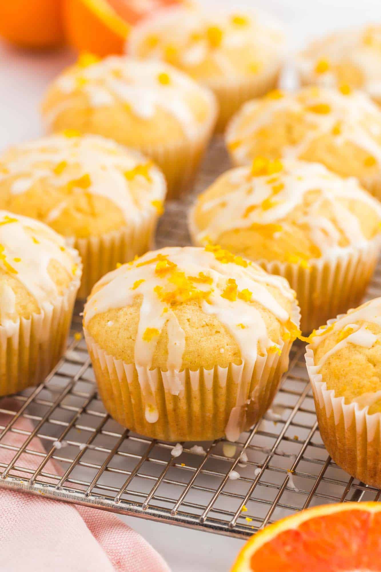 Iced orange muffins on a wire rack