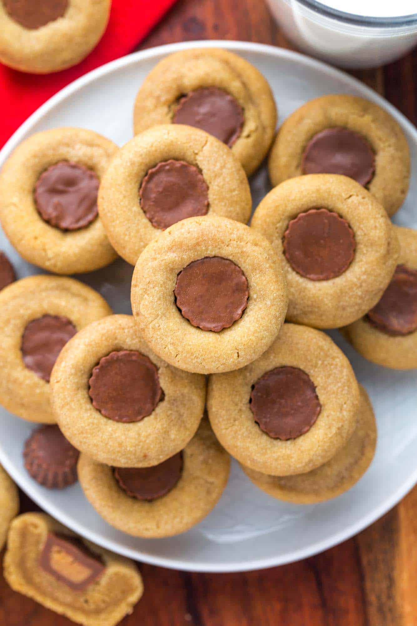 Overhead shot of peanut butter cup cookies stacked on a plate
